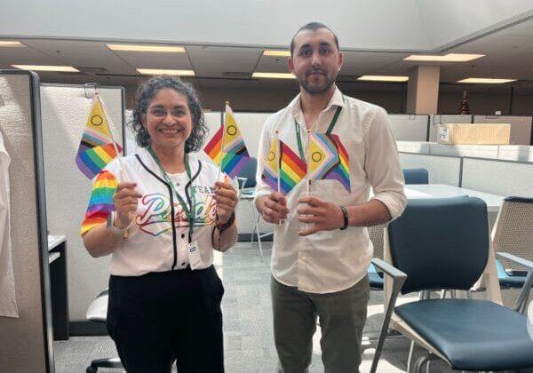 ISANS staff at office holding Pride banners