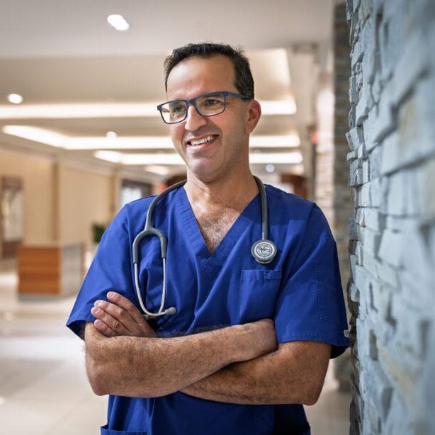 A male nurse wearing blue scrub
