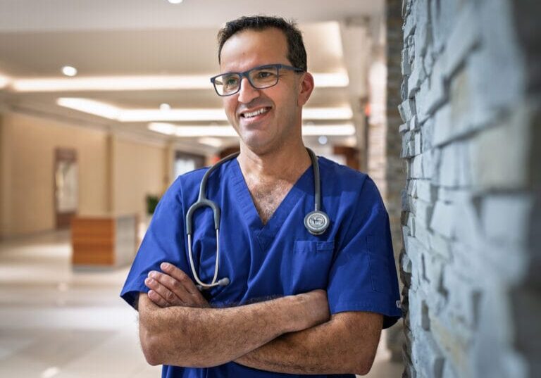 A male nurse wearing blue scrub
