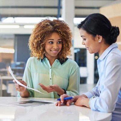A skilled immigrant woman talking to a professional mentor
