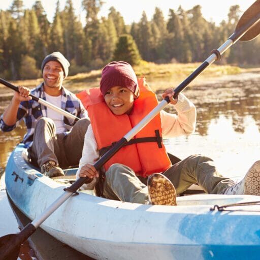 Father and son kayaking on a lake