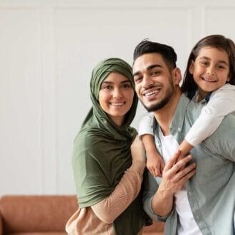 Newcomers family smiling and enjoying their new home