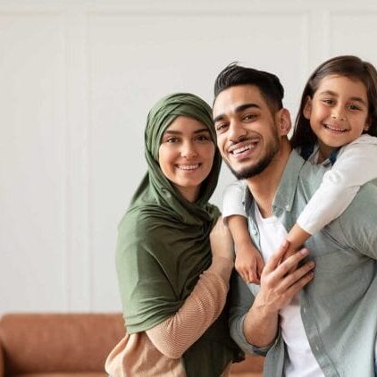 Newcomers family smiling and enjoying their new home