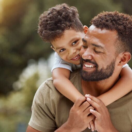 A newcomer father carrying his child on his back having fun