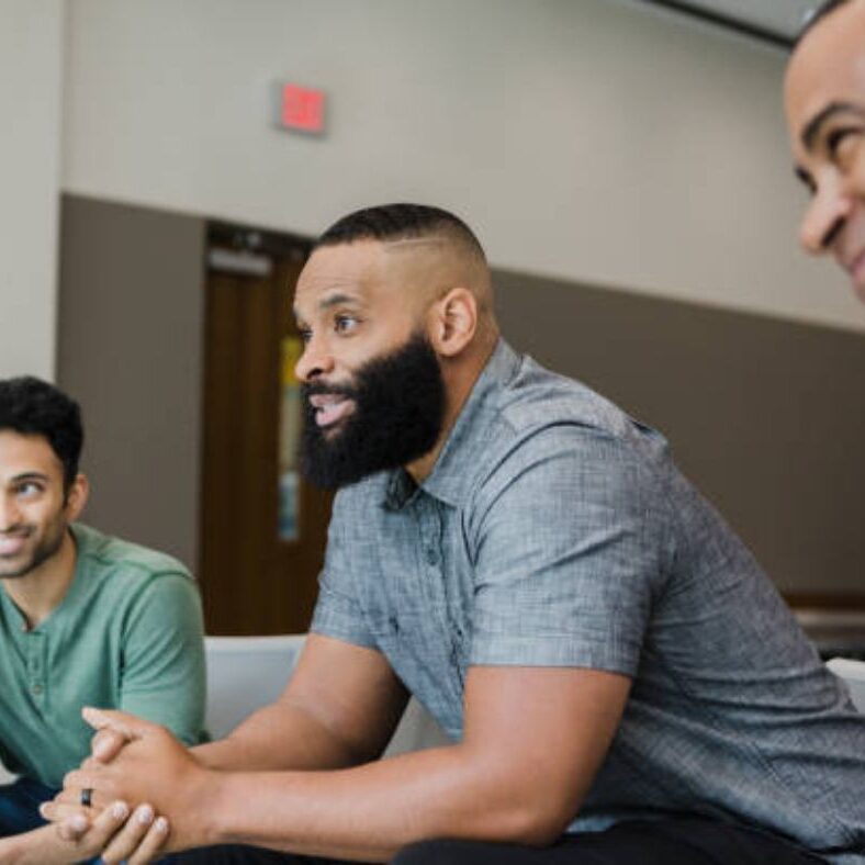 Three immigrant men attending the program.