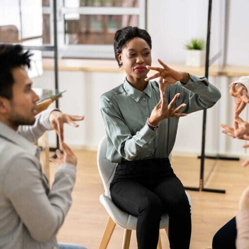 A diverse group using sign language to each other