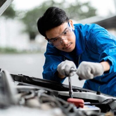 An internationally trained mechanic fixing a car
