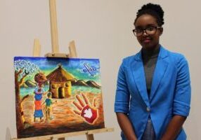 Chadia Kayinamura, 23, stands with a painting inspired by her refugee experience. Born in the Congo, she and her family spent 17 years as refugees in Uganda before immigrating to Canada last year.  (TARYN GRANT / STARMETRO HALIFAX)