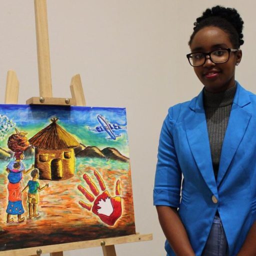 Chadia Kayinamura, 23, stands with a painting inspired by her refugee experience. Born in the Congo, she and her family spent 17 years as refugees in Uganda before immigrating to Canada last year.  (TARYN GRANT / STARMETRO HALIFAX)