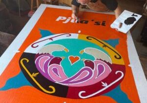 Lorne Julien working on his mural Mi'kmaki