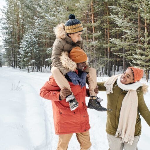 Immigrant family wearing winter clothes and enjoying the snow